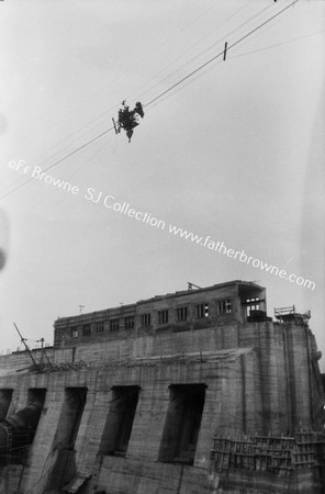 SHANON SCHEME : RENEWING A LAMP IN THE OVERHEAD CIRCUIT FROM THE TROLLYOF THE TRAVELLING CRANE - WHICH HOUSE OVER UPLAKE DAM IN BACKGROUND